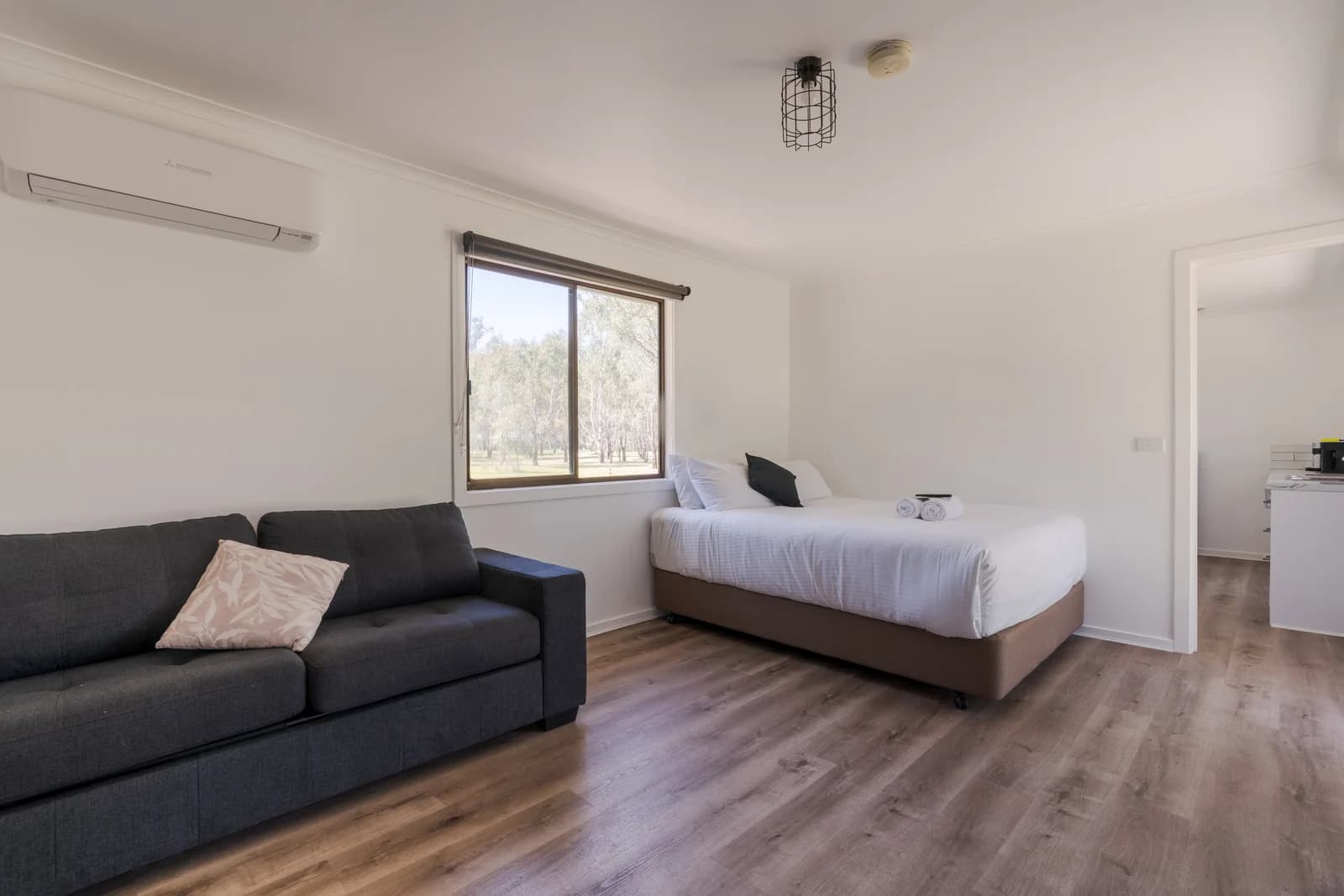 A self-contained cabin with bed, sofa and kitchenette